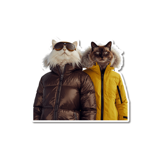 Three cats in colorful puffer jackets standing in the snow with mountains in the background, adventure cat sticker for water bottles.