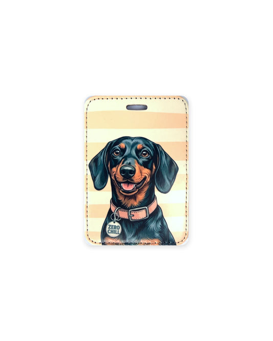 Black and tan dachshund luggage tag with an original design of a doxie wearing a pink collar and a round charm that reads "Zero Chill", on peach and cream stripes. Faux leather luggage tag with stitched edges and a slot at the top.