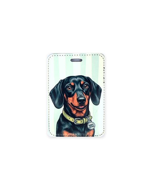 Black and tan smooth coat dachshund luggage tag with an original design of a doxie wearing a lime green collar and a round charm that reads "100% Extra", on mint and cream stripes. Faux leather luggage tag with stitched edges and a slot at the top.