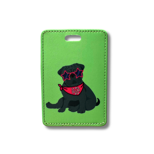 Funny black pug luggage tag. Green background. Pug is wearing red star shaped glasses and a red bandana that says "in my IDGAF era"