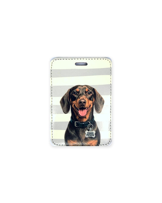 Chocolate and tan dachshund luggage tag with an original design of a doxie wearing a black collar and a bone-shaped charm that reads "Chaos Potato", on gray and cream stripes. Faux leather luggage tag with stitched edges and a slot at the top.