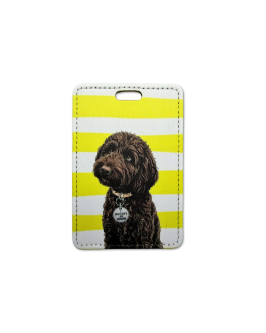 chocolate labradoodle luggage tag flat lay showing curly brown Labradoodle with I IDENTIFY AS HUMAN round collar charm on yellow and white horizontal striped faux leather travel tag
