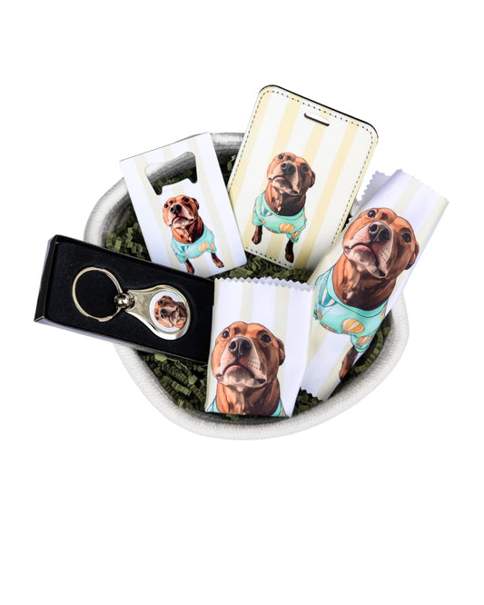 custom dog gift box contents showing personalized keychain bottle opener luggage tag and lens cloths featuring a brown dog portrait arranged in a white rope basket