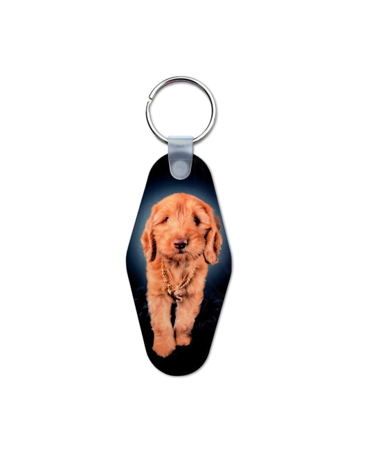 Custom motel keychain with goldendoodle puppy photo printed on black oval fob, white background, front-facing standing pose