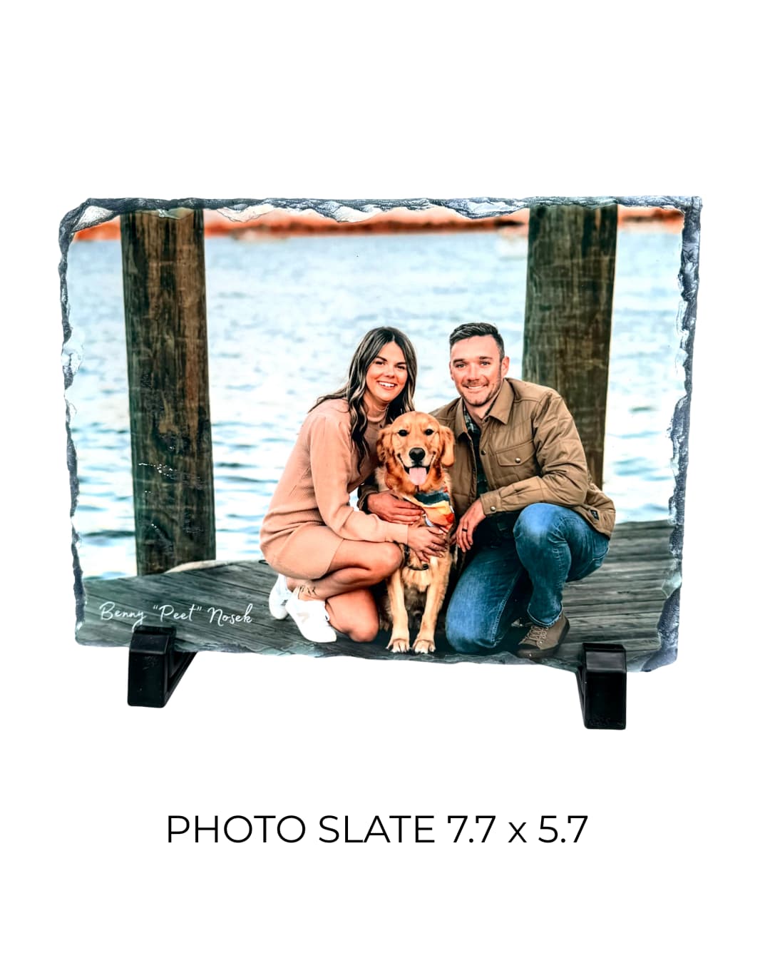 Rectangular 7.7 x5.7 inch dark gray photo slate on silver wire display stand, showing a couple with a golden retriever on a dock outdoors, demonstrating print quality and slate thickness, personalized pet memorial keepsake by Sly Dawg Studio