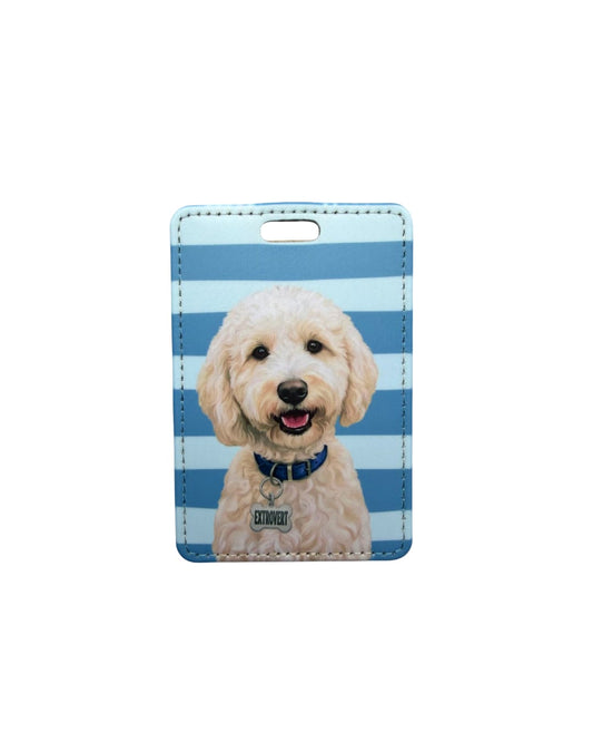 Cute doodle dog luggage tag; Fun faux leather luggage tag with a smiling cream Goldendoodle illustration wearing a blue collar with an Extrovert charm, light blue and white horizontal stripes, white background.