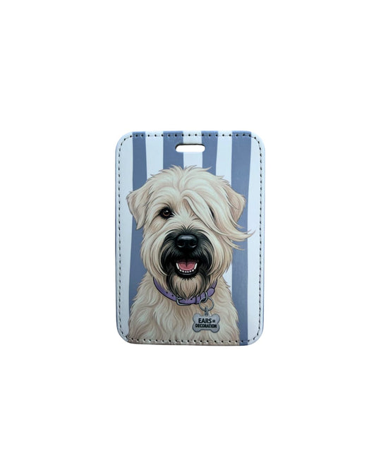 Cute wheaten terrier luggage tag; Fun faux leather luggage tag featuring a fluffy honey-colored Wheaten Terrier with a purple collar and Ears Equal Decoration charm, vertical light blue and white stripes, white background.