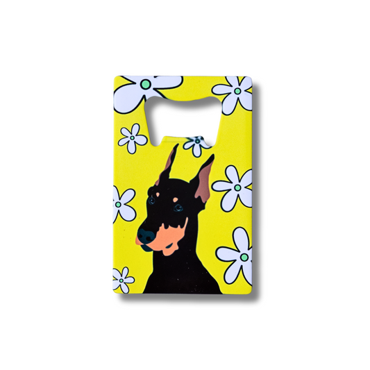 Bottle opener with a doberman dog design on a yellow background with flowers