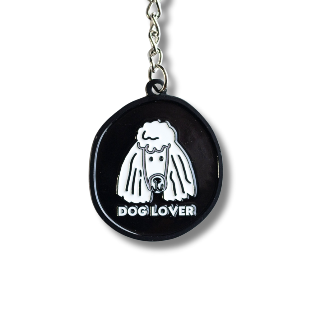 Cute minimalist black and white enamel poodle keychain with text: dog lover