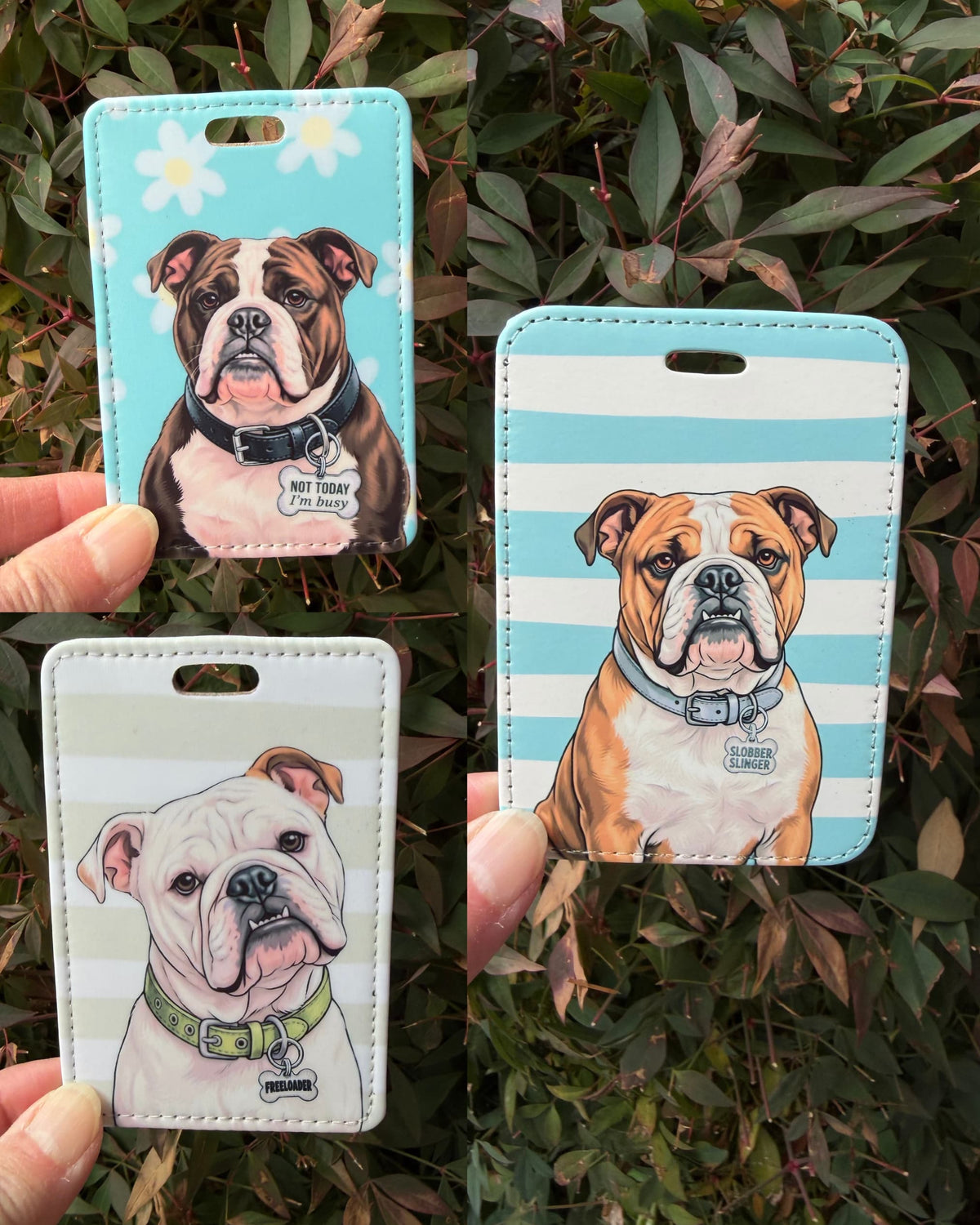 Three English Bulldog luggage tags over green leaves: dark brindle on blue daisies, fawn on blue stripes, white on sage stripes with FREELOADER charm