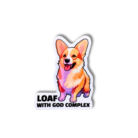 Funny corgi vinyl sticker with orange and pink tones and bold text “Loaf With God Complex”