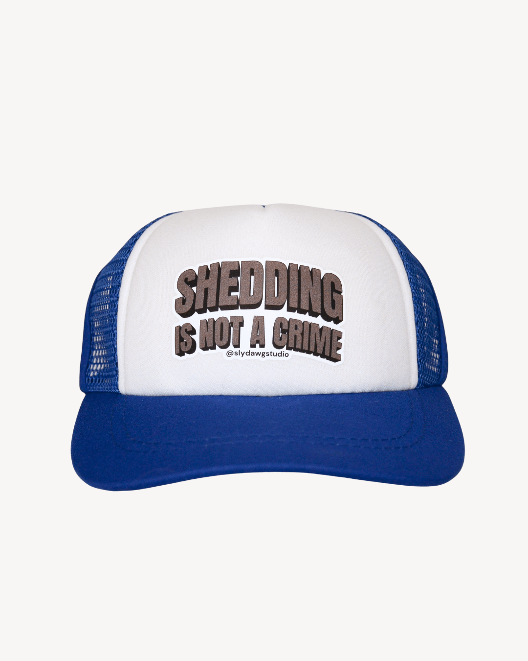 Funny dog hat with saying blue; blue and white Shedding is Not a Crime dog trucker hat, front view on white background.