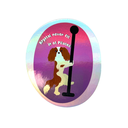 Holographic dog sticker with a King Charles dog holding a pole and text 'Krystal never fit in at Pilates' on a colorful background.