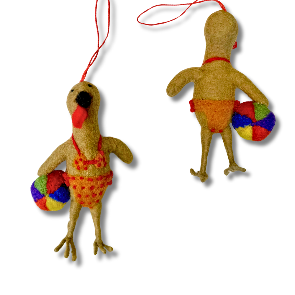 Fun turkey ornament -- the turkey is wearing a yellow and red bikini and holding a colorful beach ball. 