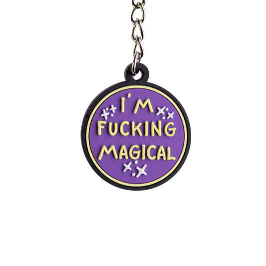 Funny purple keychain with raised yellow letters that says I'm F*cking Magical. Close up view