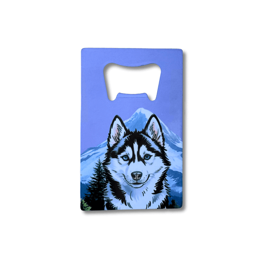 Husky bottle opener; dog in front of mountain with lavender sky on white background