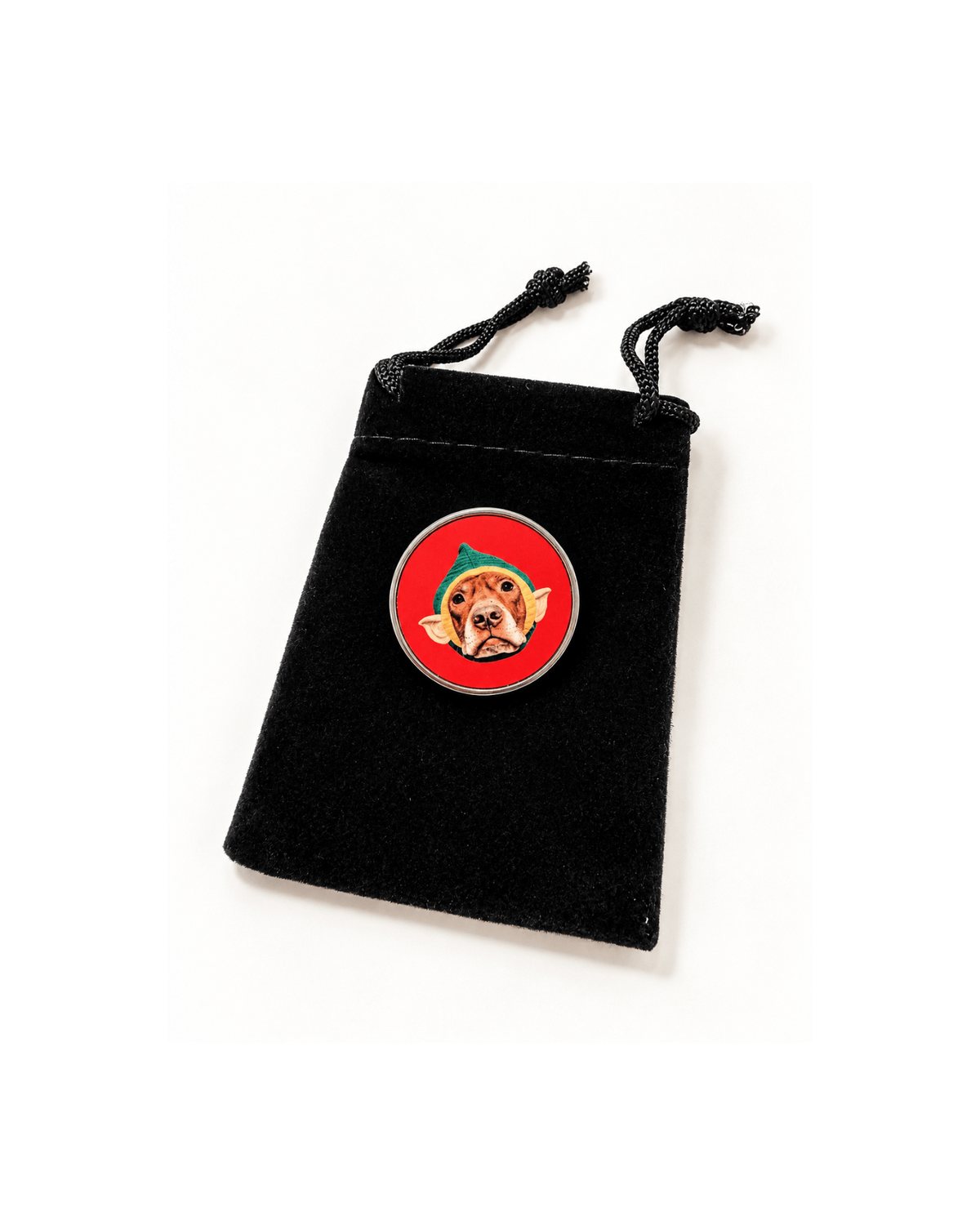 Opie elf lapel pin on its black velveteen gift bag, a dog pin that gives back to animal rescue