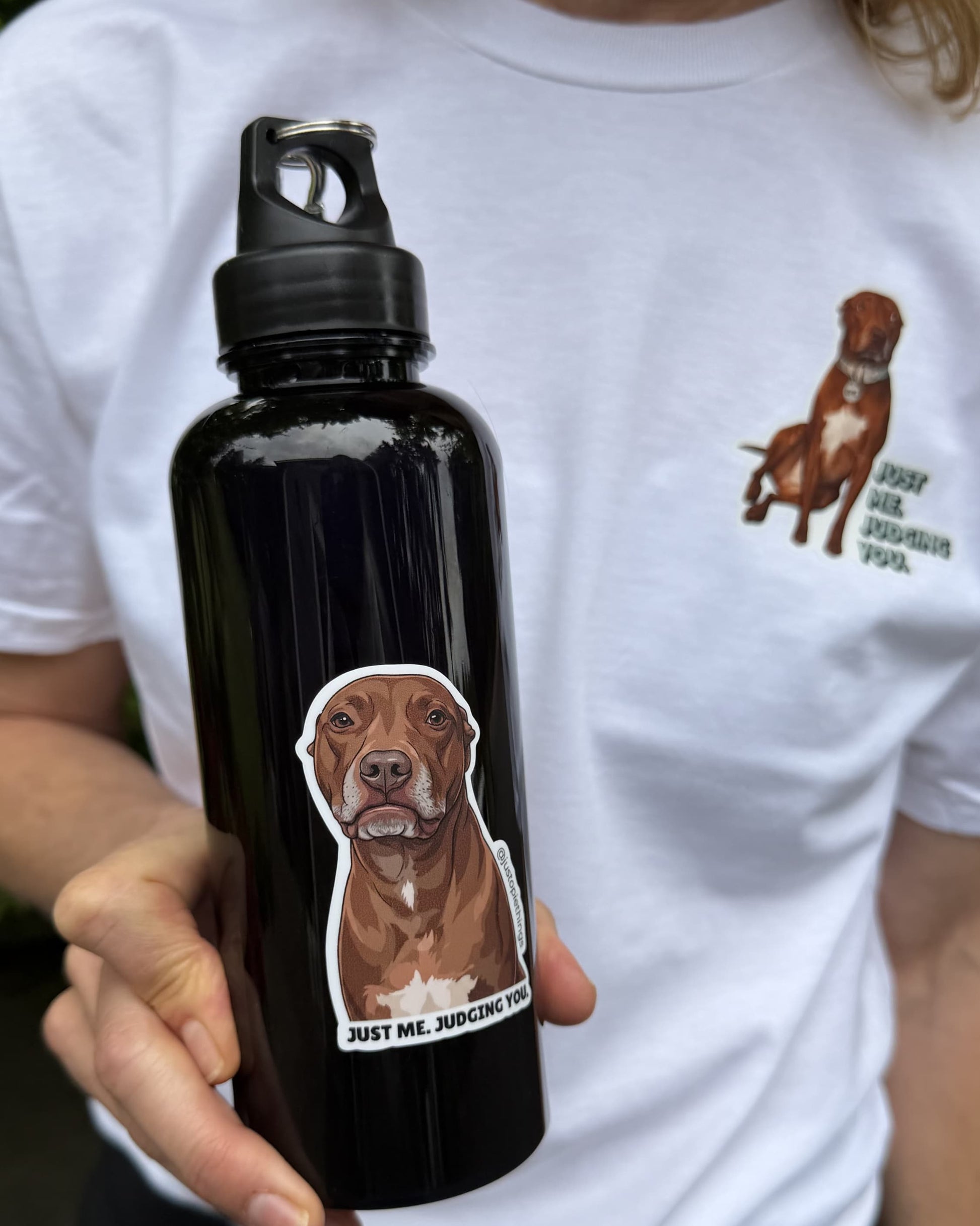 Opie judging you sticker applied to a black water bottle held by a person wearing a white Opie graphic tee