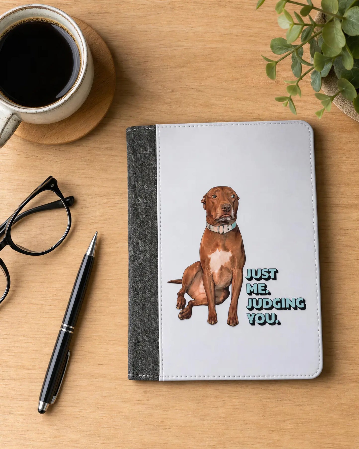 Opie reusable notepad portfolio on wood desk with coffee, glasses and pen, Just Me. Judging You. pit bull cover design, official justopiethings merch by Sly Dawg Studio