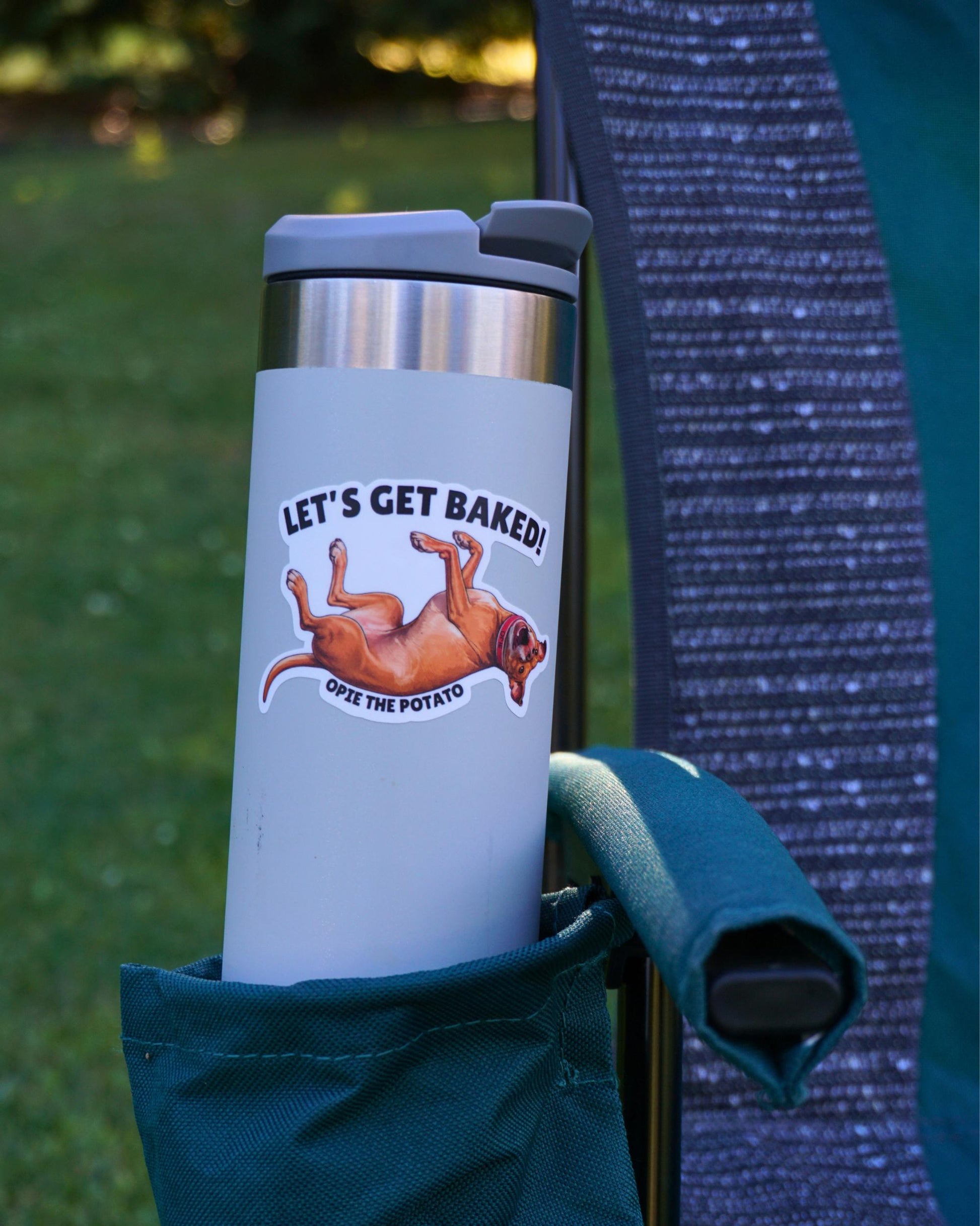 Opie Let's Get Baked sticker on white stainless steel water bottle in camp chair cup holder, Opie the Potato pit bull sticker by Sly Dawg Studio