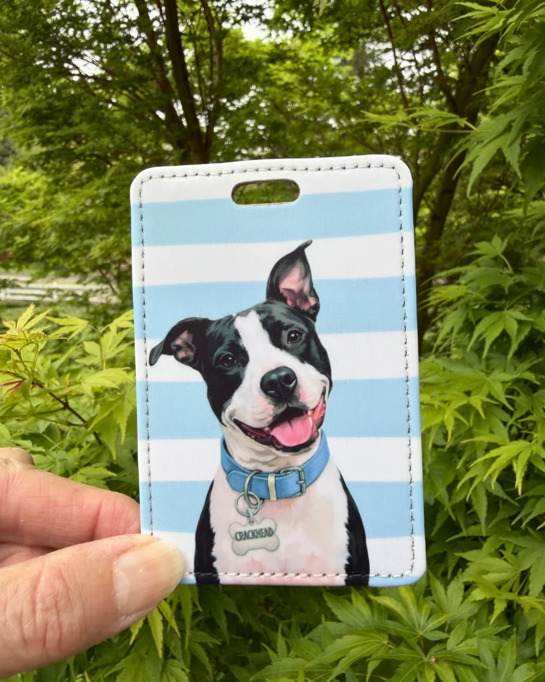 pitbull suitcase tag handheld showing black and white pit bull illustration with blue collar on blue and white striped faux leather travel tag