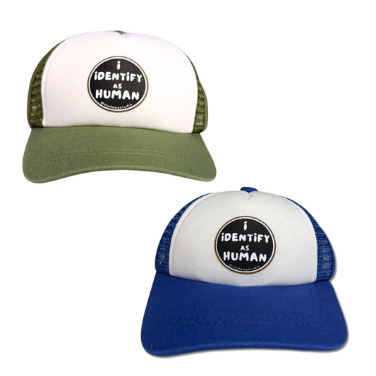 Two Pup Lid dog trucker hats (one olive/white and one blue/white) with 'I Identify as Human' design on a white background