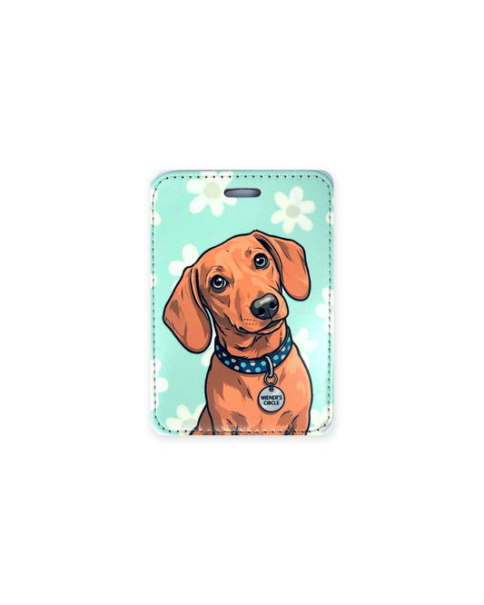 Red smooth coat dachshund luggage tag with an original design of a doxie wearing a blue polka dot collar and a round charm that reads "Wiener's Circle", on an aqua floral background. Faux leather luggage tag with stitched edges and a slot at the top.