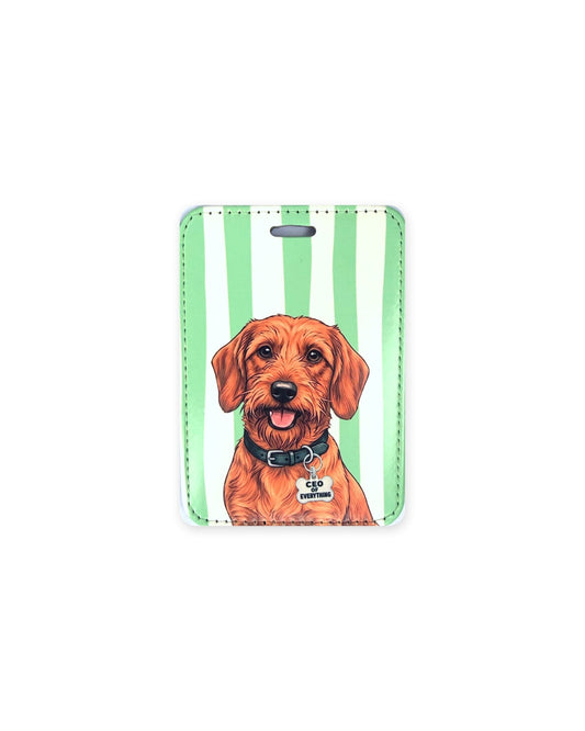 Red wirehaired dachshund luggage tag with an original design of a doxie wearing a black collar and a bone-shaped charm that reads "CEO of Everything", on green and white stripes. Faux leather luggage tag with stitched edges and a slot at the top.