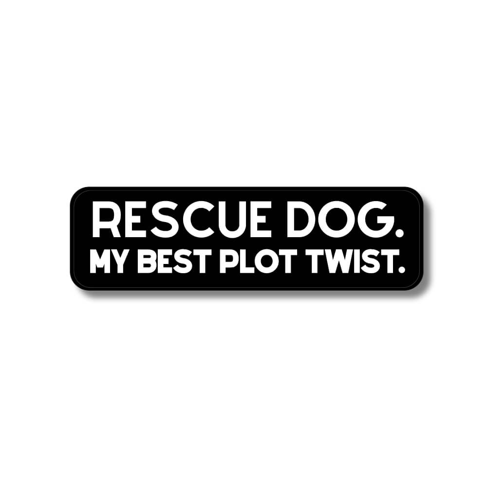Black and white dog adoption sticker with text 'RESCUE DOG. MY BEST PLOT TWIST.' white text / black background