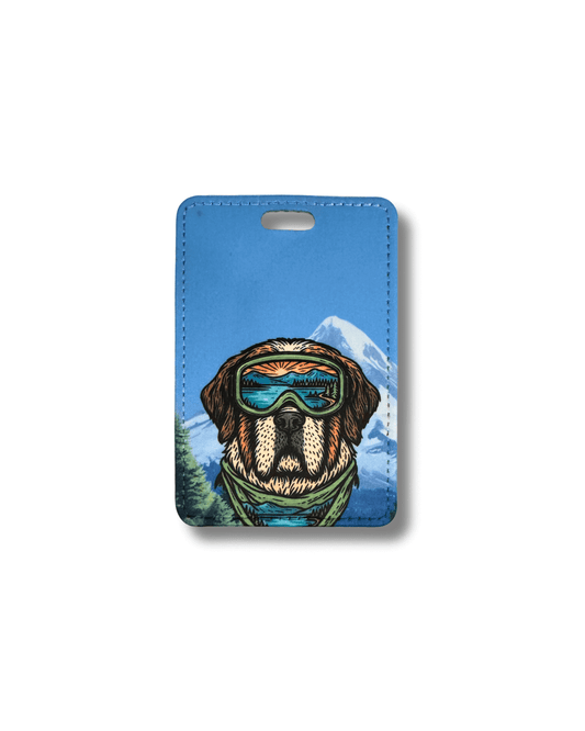 St. Bernard luggage tag with a dog wearing goggles and a mountain background