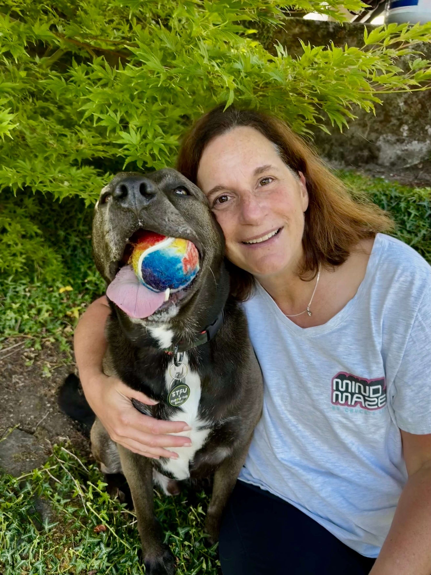 Owner of Sly Dawg Studio with the pit bull mix dog that is the logo