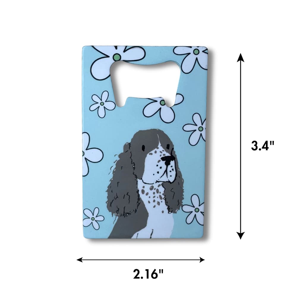 Card-shaped spaniel bottle opener with a dog illustration on a blue background with flowers, dimensions indicated.